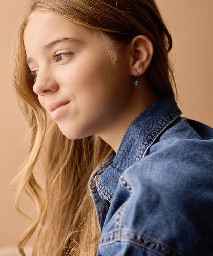 Model Wearing Golden Titanium Bicone Pendant 14mm Ear Rings in Aquamarine 